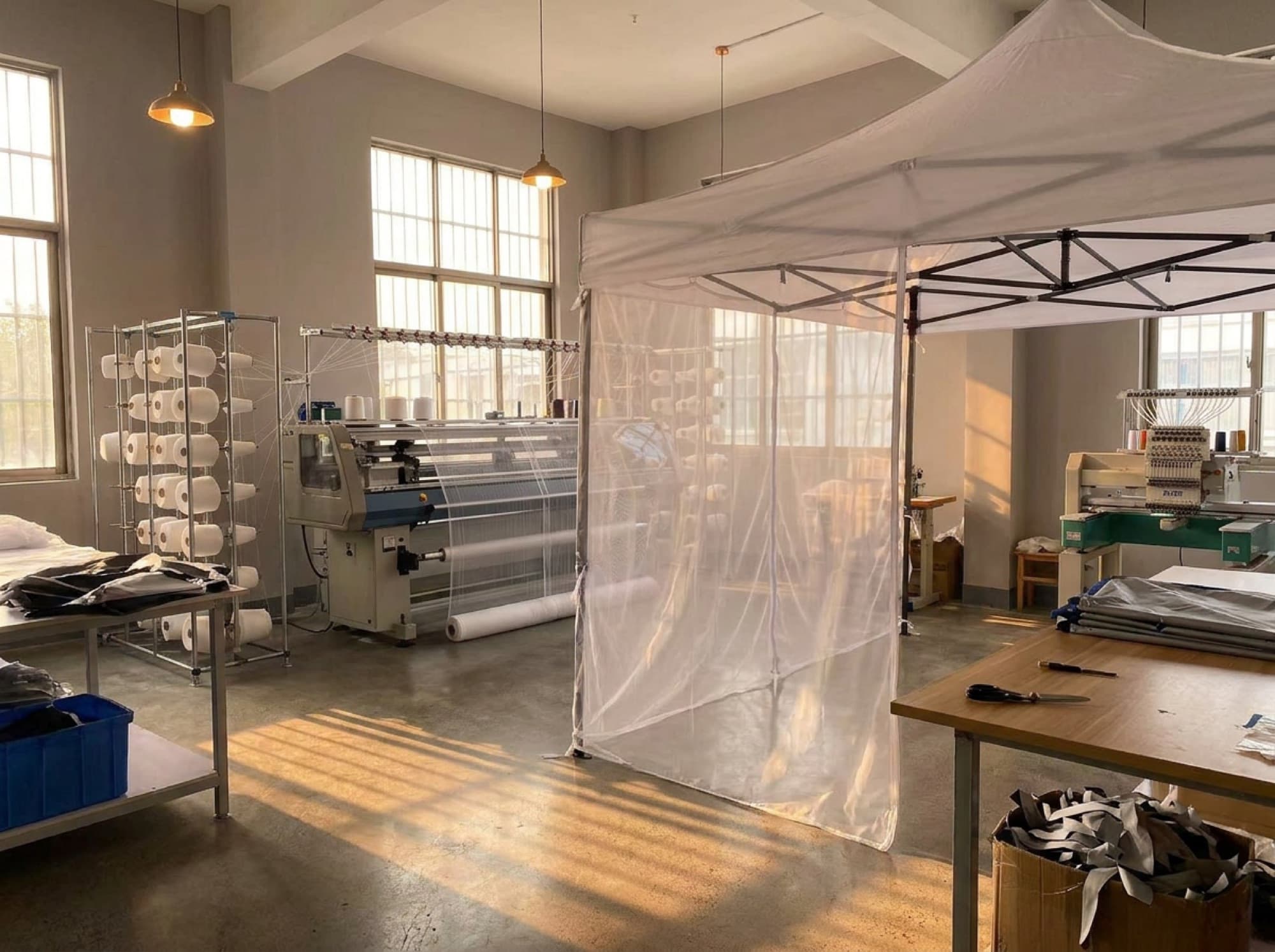 Inside the Mosticare facility, looms and mesh in daylight